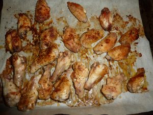 chicken wings on a baking sheet brushed with sauce