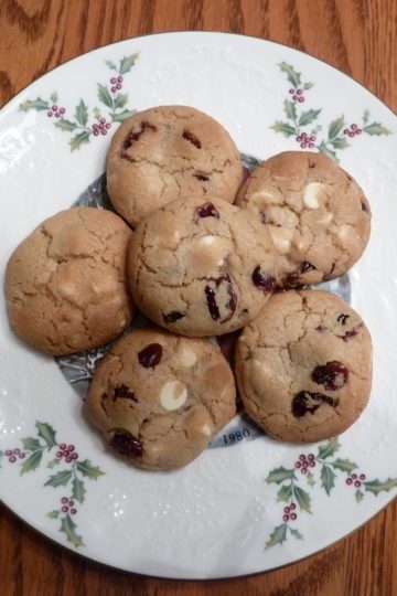 White chocolate chip cookies with cranberries on a white plate