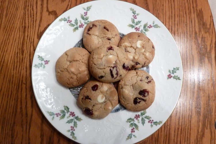 White chocolate chip cookies with cranberries on a white plate