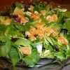 Almond and clementine salad on a clear plate