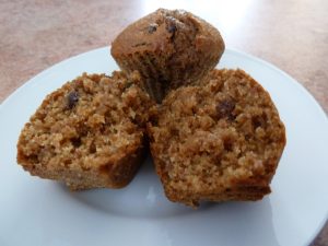 bran muffins on a plate, one cut in half