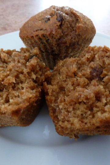 bran muffins on a plate, one cut in half