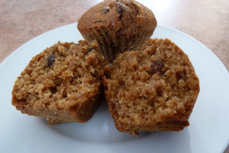 bran muffins on a plate, one cut in half