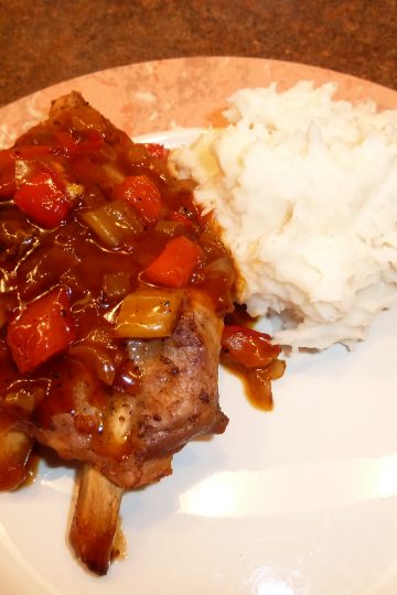 Baked spare ribs plated with mashed potatoes