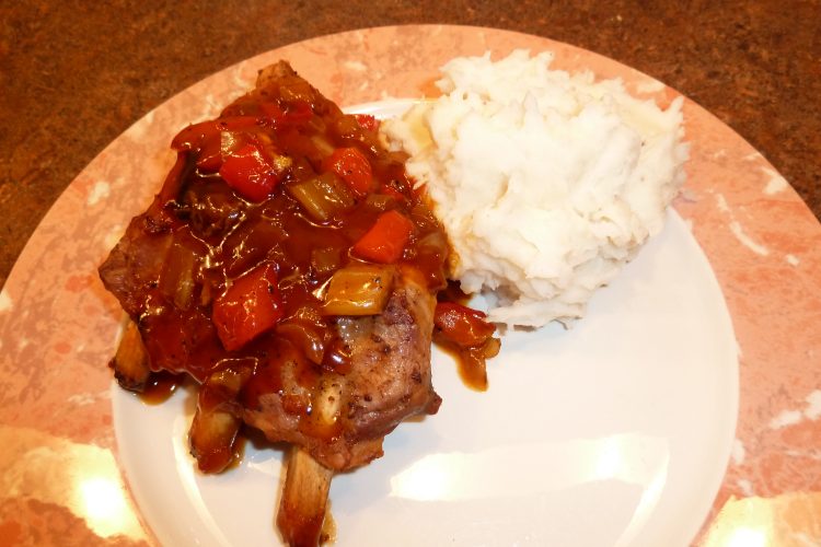 Baked spare ribs plated with mashed potatoes