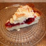 Slice of cherry coffee cake on glass plate