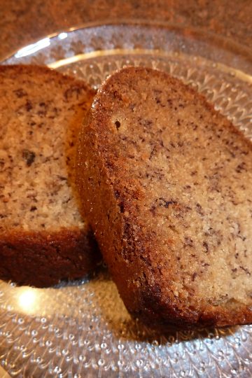 two slices of fresh banana bread on a glass plate