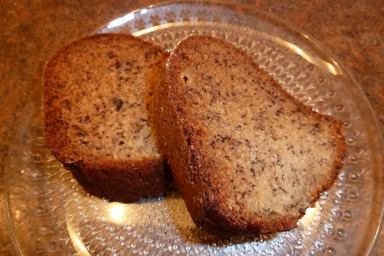 two slices of fresh banana bread on a glass plate