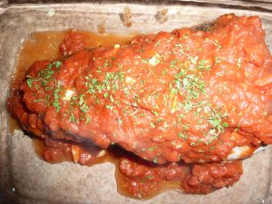 Salmon topped with bacon and sauce