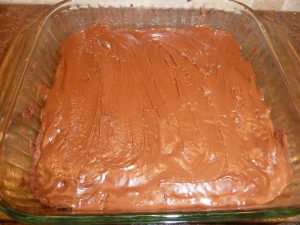 Shows brownies in the pan after they are frosted