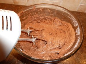 shows the beater mixing the chocolate frosting