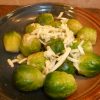 Cooked brussels sprouts topped with Asiago cheese