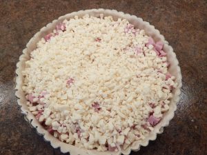 Uncooked ham quiche in a pieplate