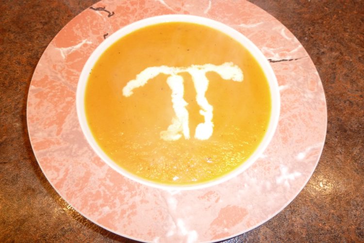 Sweet Potato and Pear Soup in a bowl with a Pi in creme fraiche