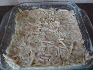 Apple cake mixture spread in baking dish